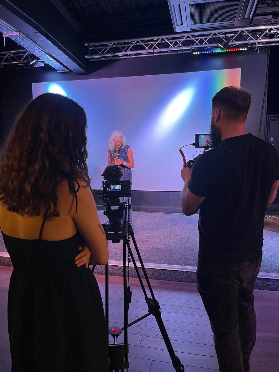 Behind the scenes on a studio shoot with lighting and a camera on a tripod