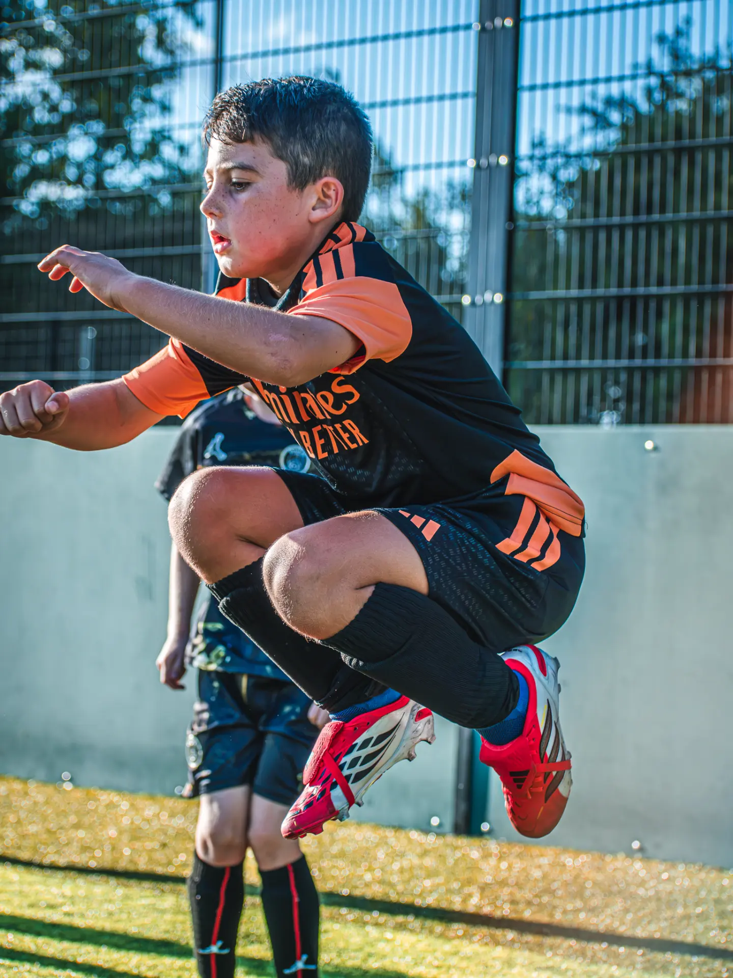 Young player mid-jump during a fitness drill