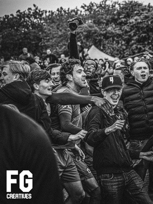 Black and white photograph of a football crowd celebrating