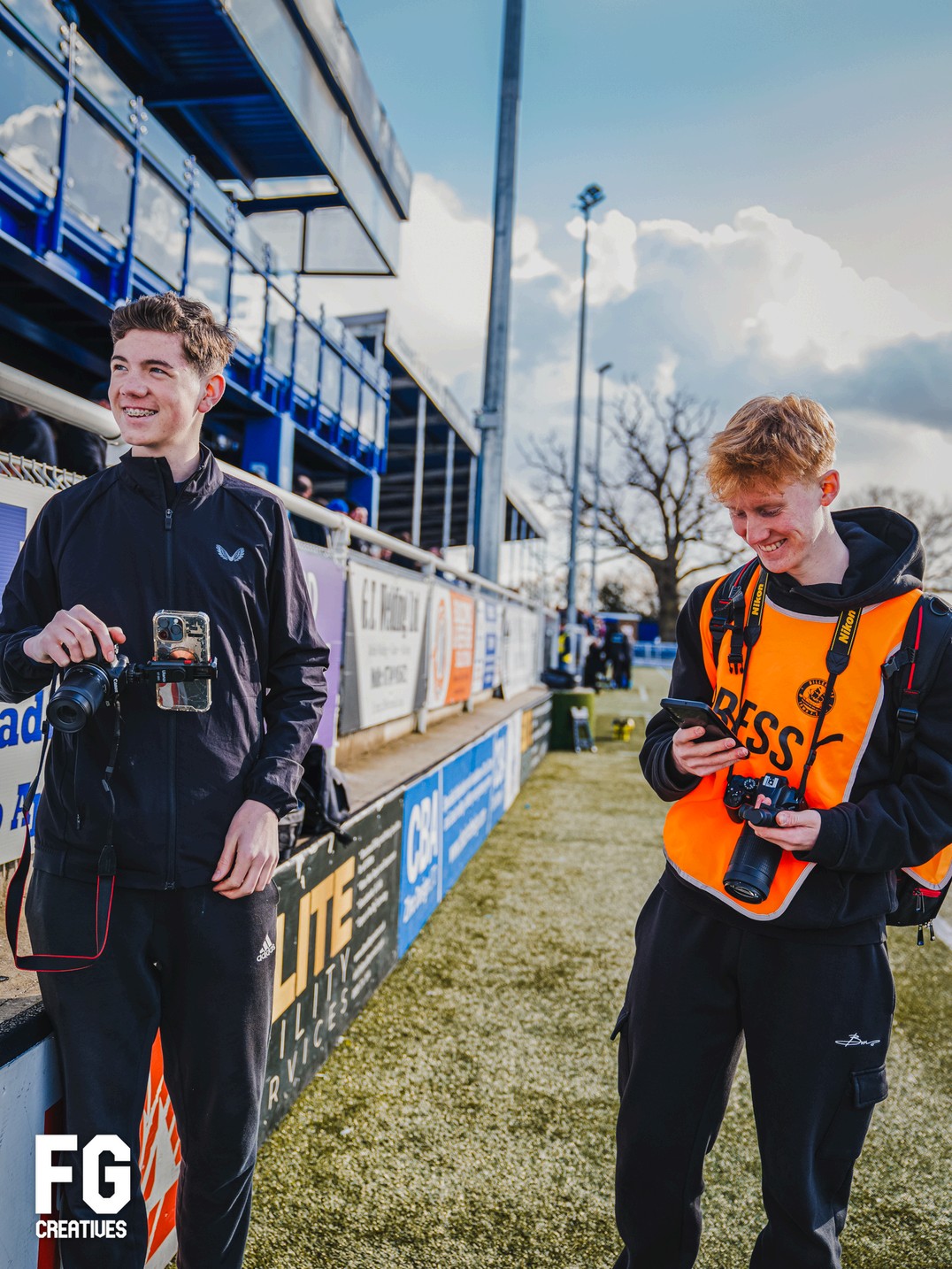Flynn on the touchline with a fellow media creator at a football match