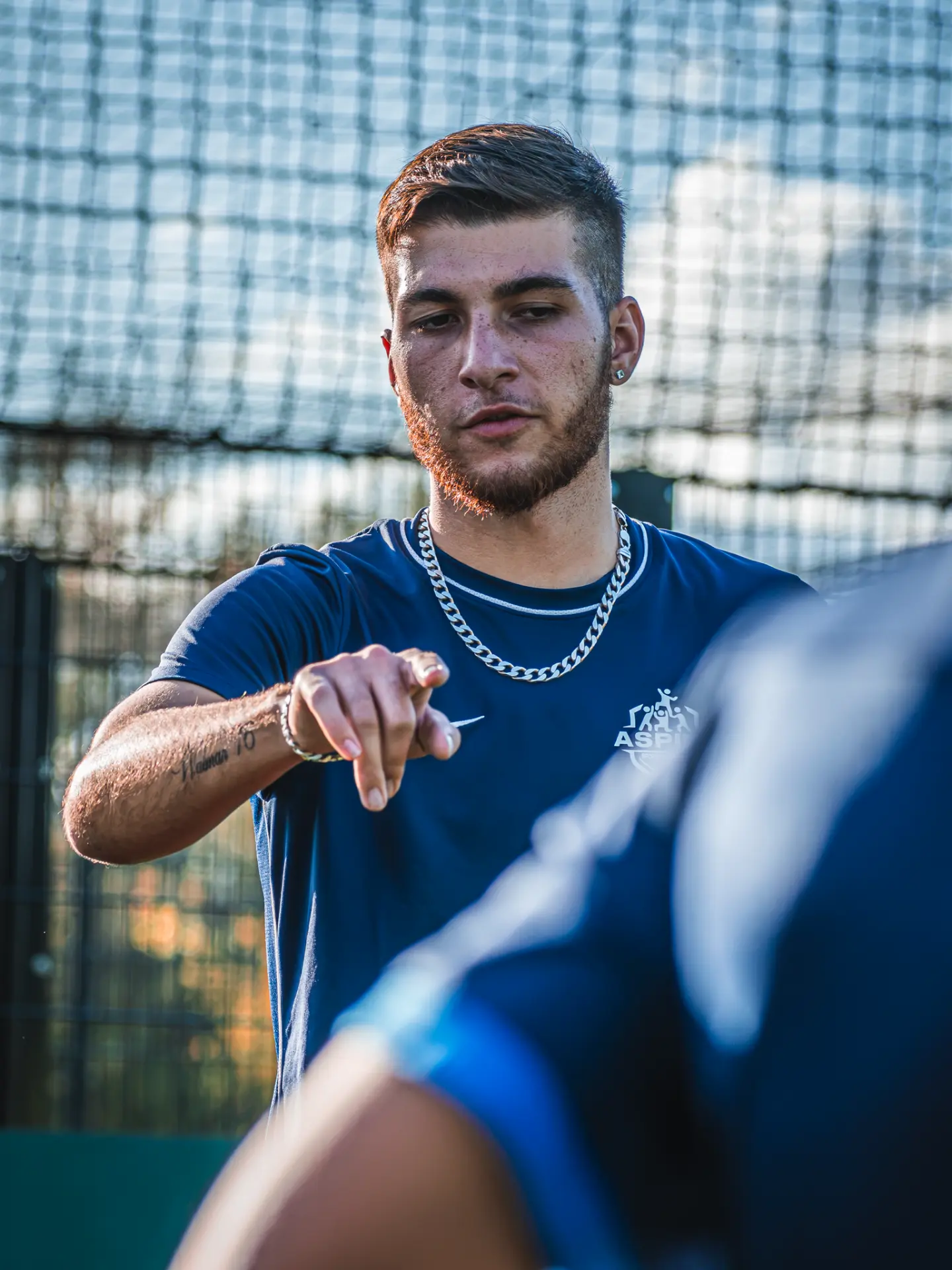 Aspire coach giving instructions to a player