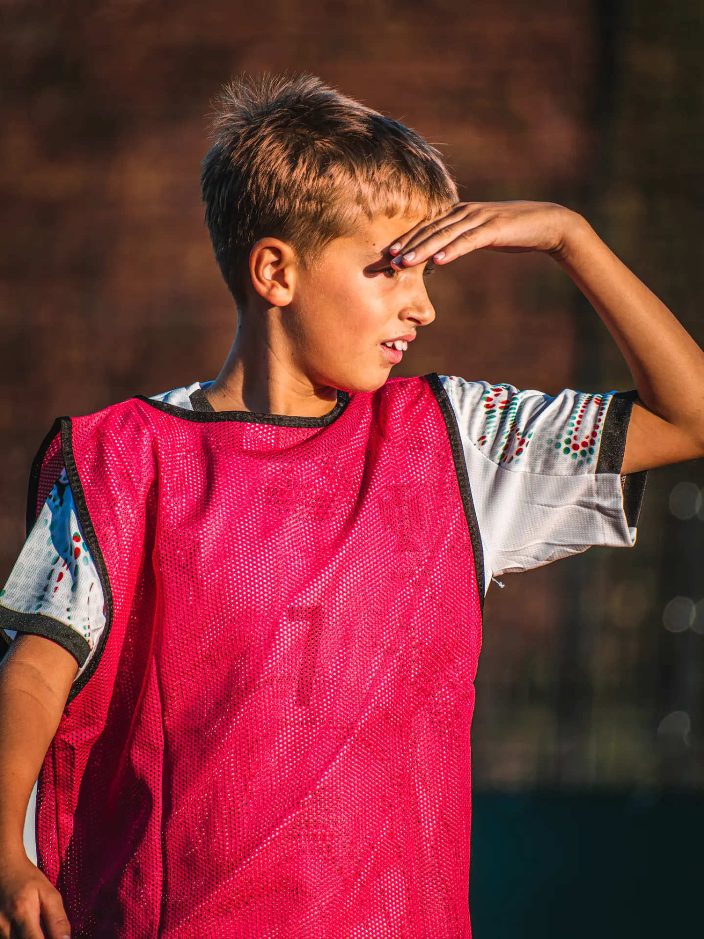 Player shielding his eyes from the sun in golden light